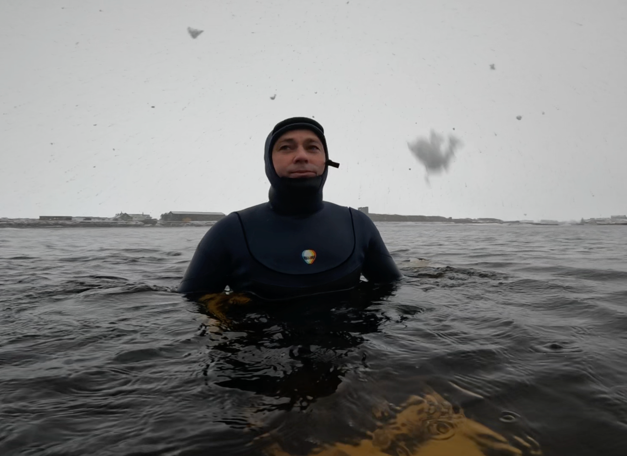 Ian Battrick cold water surfing in a Lunasurf 4mm Arc Zip Yamamoto neoprene wetsuit during a winter snow storm at Thurso East, Scotland