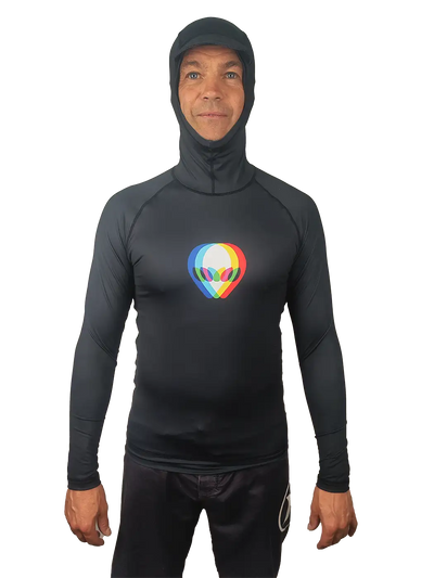 A man wearing a black hooded long-sleeve rash guard or swim shirt with a colourful 3d effect alien graphic logo on the chest, shown against a plain white background.