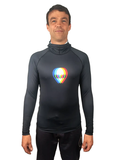 A man wearing a black long-sleeve rash vest with a colorful alien head graphic on the chest, set against a plain white background.