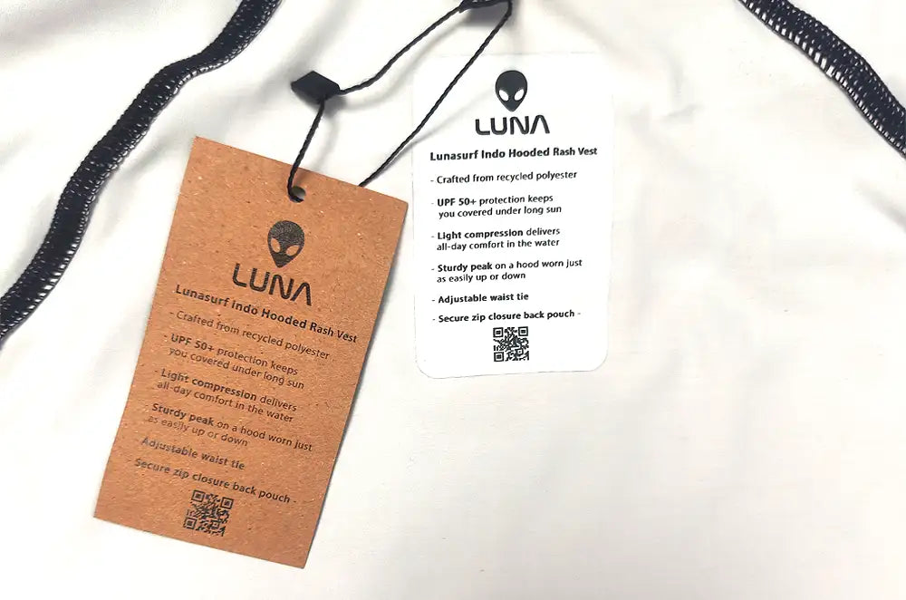 A LUNA hooded rash vest shown with its retail hangtag and care card.